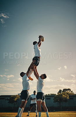 Buy stock photo Cropped shot of a handsome young rugby player catching the ball during a lineout on the field