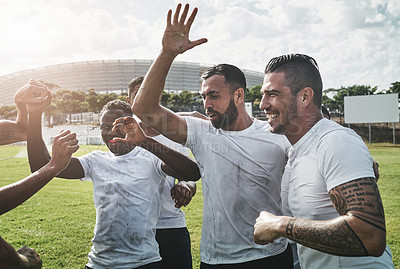 Buy stock photo Cropped shot of a group of cheerful young rugby players celebrating their win after a match outside during the day