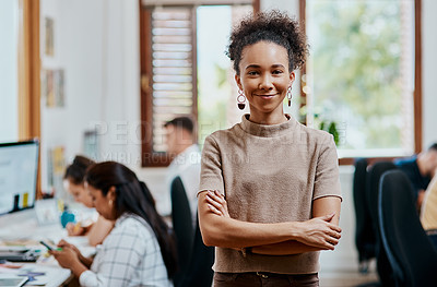 Buy stock photo Portrait of a confident young businesswoman working in a modern office with her team in the background