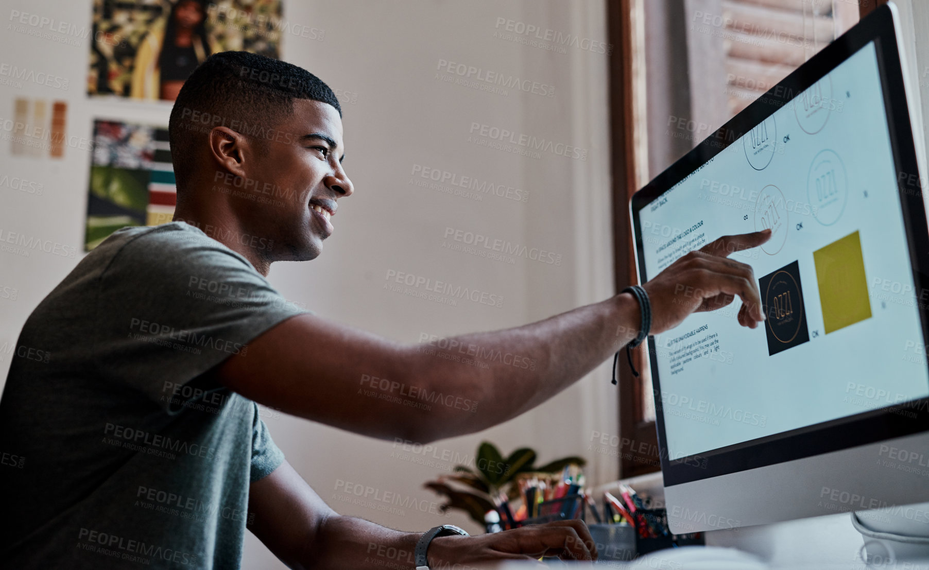 Buy stock photo Shot of a young businessman using a computer in a modern office