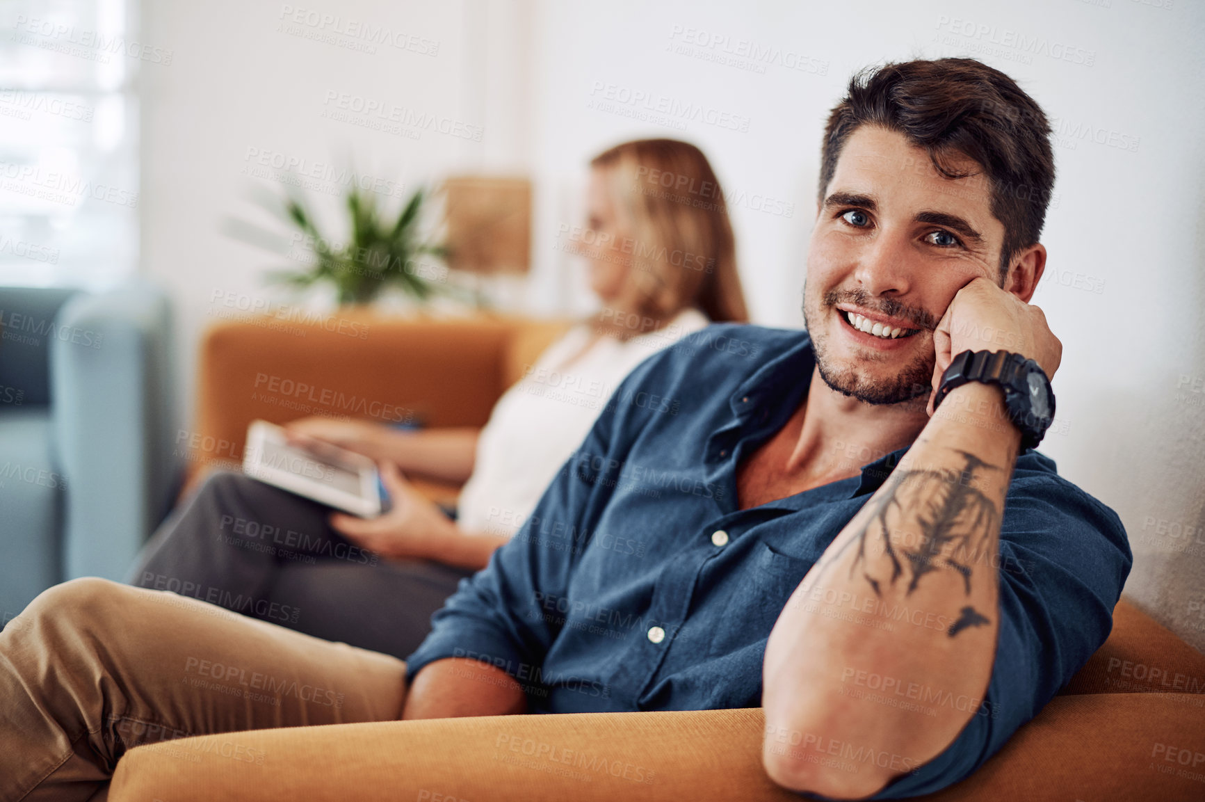 Buy stock photo Cropped portrait of a handsome young businessman sitting with a female colleague in the office