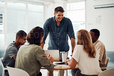 Buy stock photo Cropped shot of a diverse group of businesspeople having a meeting in the office together during the day