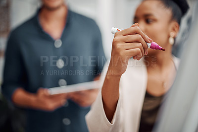 Buy stock photo Cropped shot of an attractive young businesswoman using a visual aid to brainstorm with her colleagues in the office