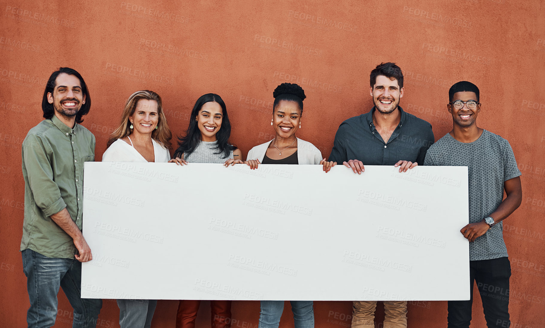 Buy stock photo Cropped portrait of a diverse group of businesspeople standing together and holding a sign while outside