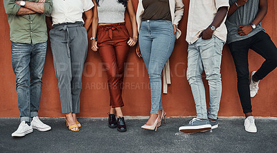 Buy stock photo Cropped shot of an unrecognizable group of businesspeople standing together against a wall outside