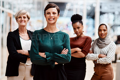 Buy stock photo Portrait of a young businesswoman standing in an office with her colleagues in the background