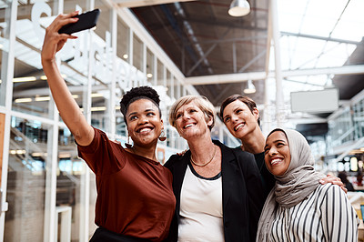 Buy stock photo Portrait of a group of businesswomen taking selfies together in an office