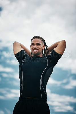 Buy stock photo Cropped shot of a handsome young rugby player throwing a ball while training on the field