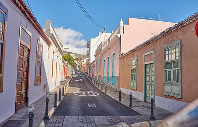 Buy stock photo Historical city street view of residential houses in small and narrow alley or road in tropical Santa Cruz, La Palma, Spain. Village view of vibrant buildings in popular tourism destination overseas 