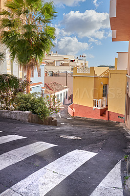 Buy stock photo A winding road with traditional architecture in 
Santa Cruz de La Palma. Quiet, empty street in a small European tourist city. A narrow alleyway in a rural town with colorful buildings and houses. 