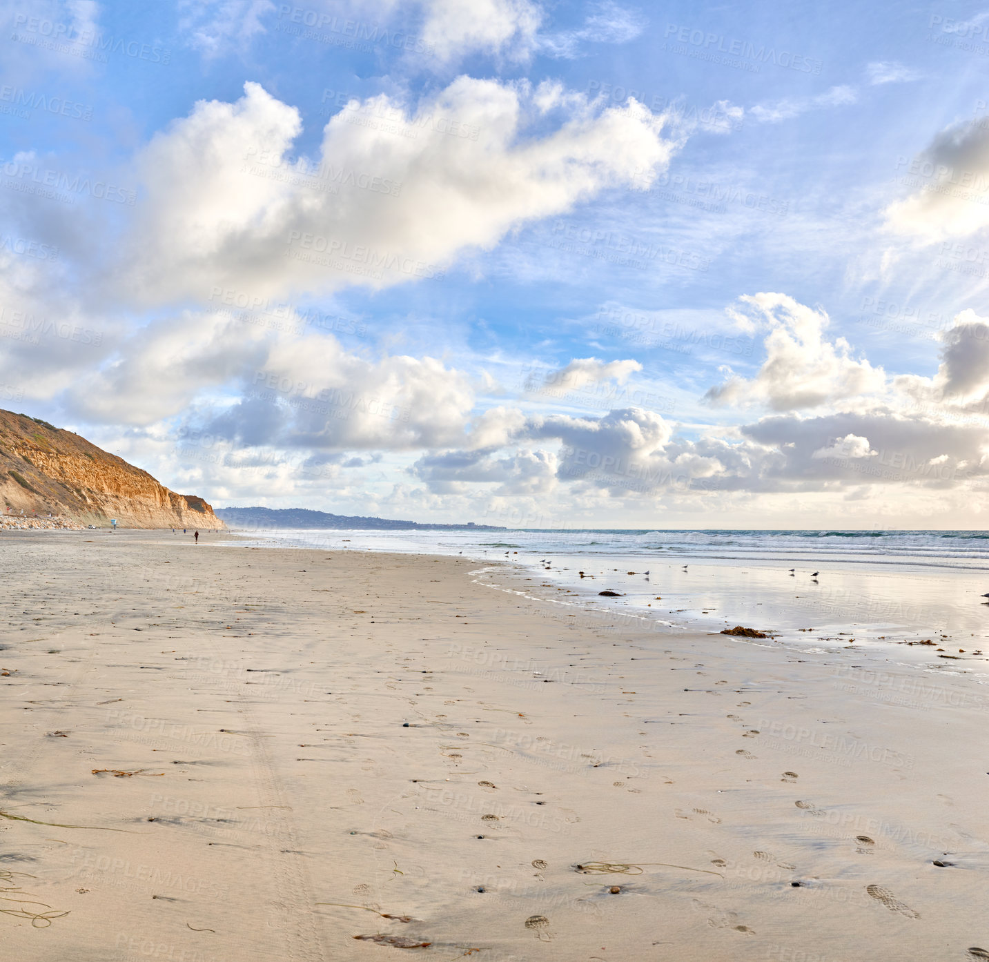 Buy stock photo The beach of Torrey Pines, San Diego, California. Landscape of empty beach showing shoreline. Walkers footprints remain in the sand as the sun starts setting and the clouds come over the sky. 