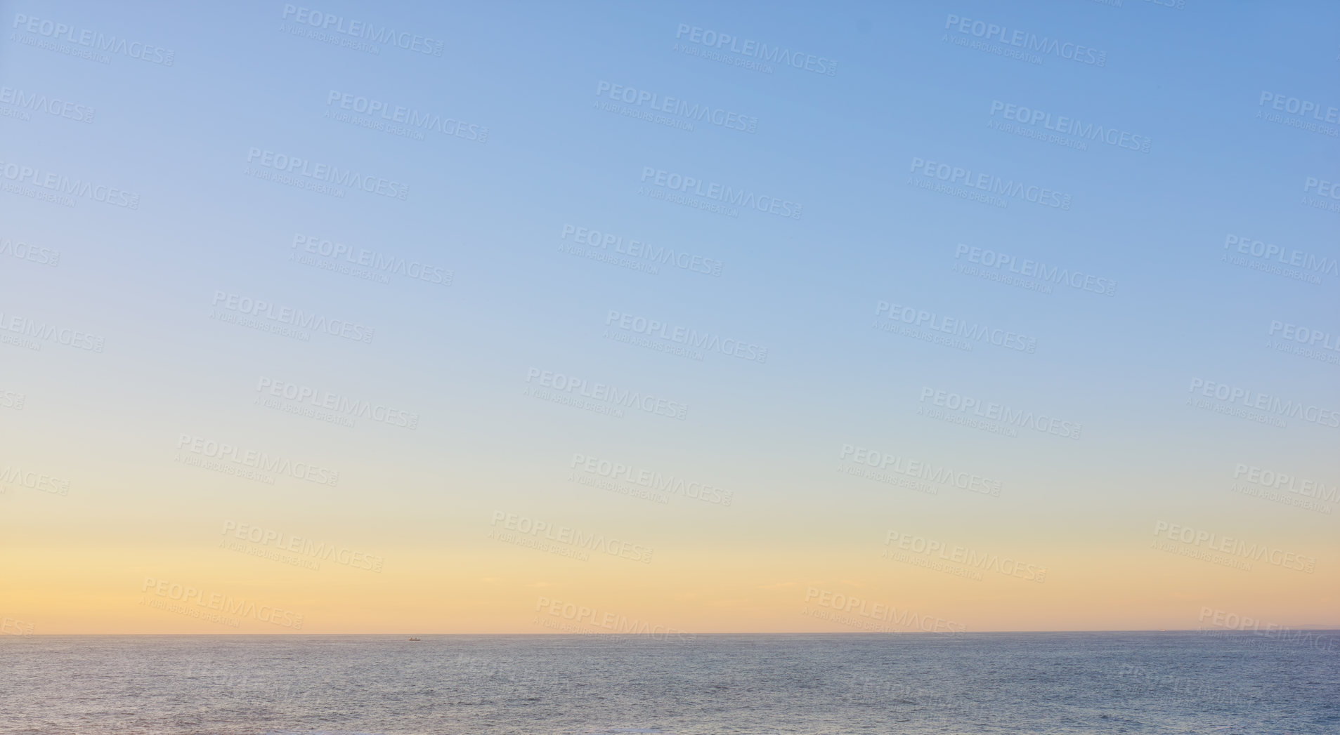 Buy stock photo Seascape of a beautiful golden sunset with copy space. Sun setting on the horizon of a calm ocean at dusk or twilight. The calm and tranquil ocean or sea in the evening with bright sky copyspace