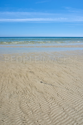 Buy stock photo Beautiful landscape of the beach with a blue sky and copy space on a summer day. Peaceful and scenic view of the ocean shore or sand on a sunny afternoon. The calm sea outdoors in nature