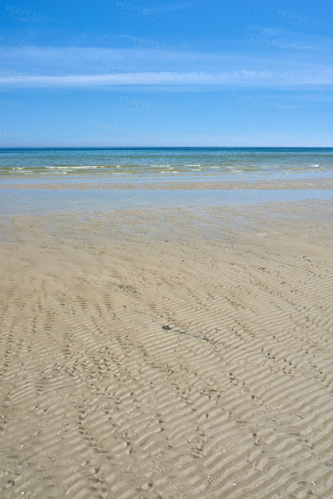 Buy stock photo Beautiful landscape of the beach with a blue sky and copy space on a summer day. Peaceful and scenic view of the ocean shore or sand on a sunny afternoon. The calm sea outdoors in nature