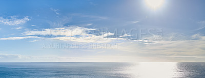 Buy stock photo Copy space at sea with the sun in a clear blue sky in the background. Calm ocean tide in an open ocean. A scenic seascape for a relaxing summer holiday with cloudy sky and clean water on the coast