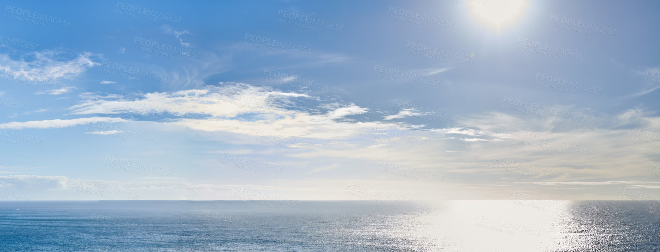 Buy stock photo Copy space at sea with the sun in a clear blue sky in the background. Calm ocean tide in an open ocean. A scenic seascape for a relaxing summer holiday with cloudy sky and clean water on the coast