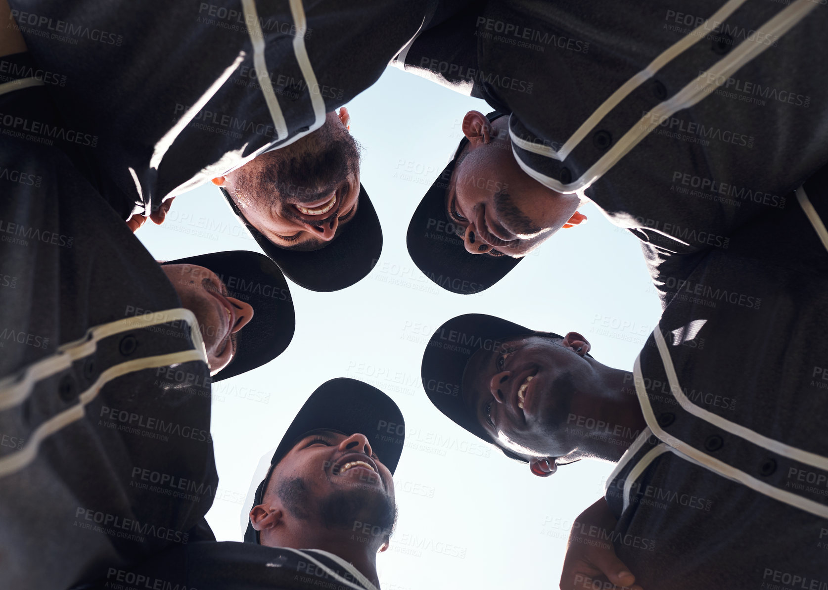 Buy stock photo Low angle shot of a group of young men huddled together at a baseball game