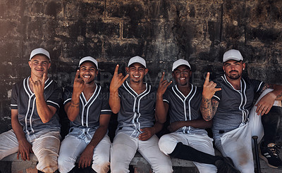 Buy stock photo Shot of a group of young baseball players sitting in the dugout and showing horn signs