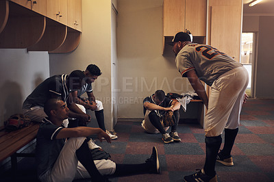 Buy stock photo Shot of a young man yelling at his fellow baseball players in a locker room