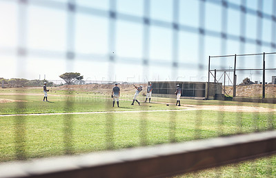 Buy stock photo Shot of a group of young men playing a game of baseball