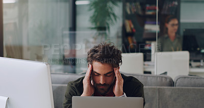 Buy stock photo Cropped shot of a handsome young businessman looking stressed while working in his office