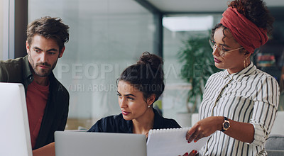 Buy stock photo Cropped shot of a group of young colleagues working together in their office