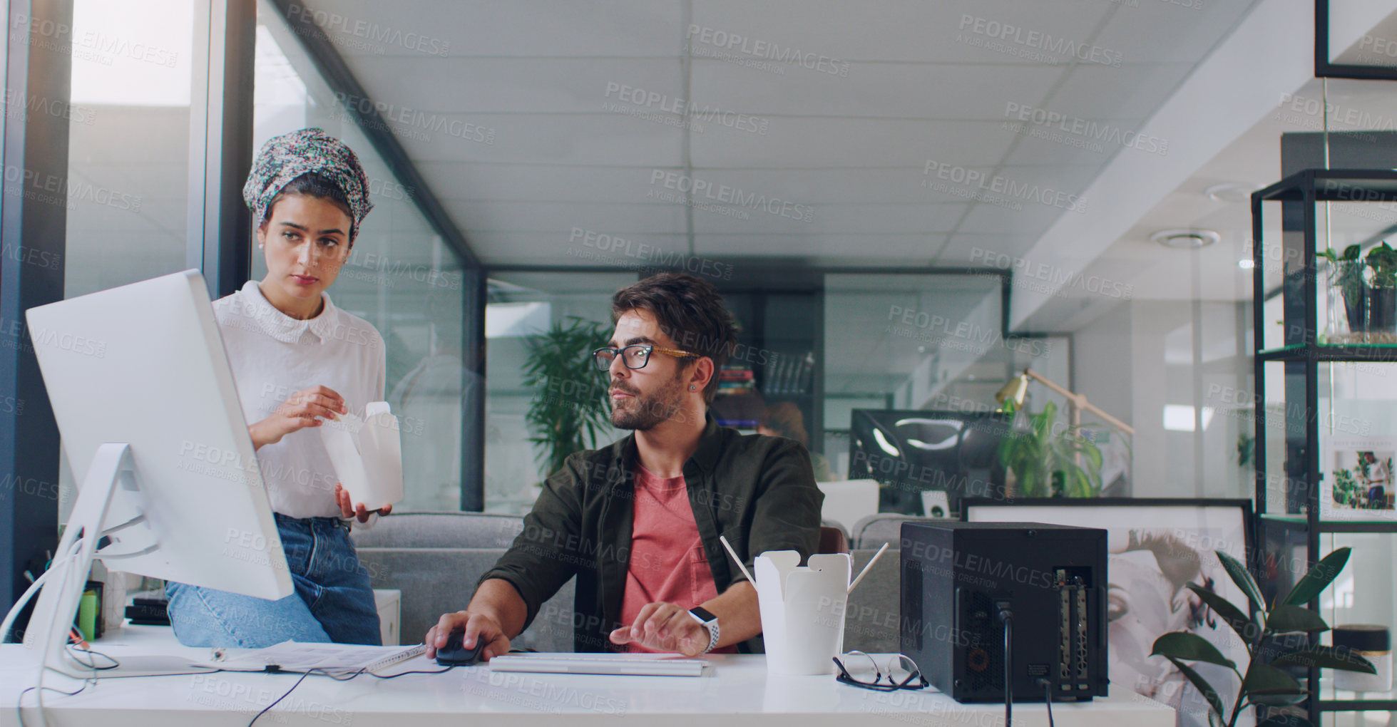 Buy stock photo Cropped shot of two young businesspeople working together in the office