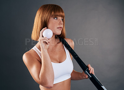 Buy stock photo Cropped shot of a beautiful young woman posing with hockey equipment against a grey background