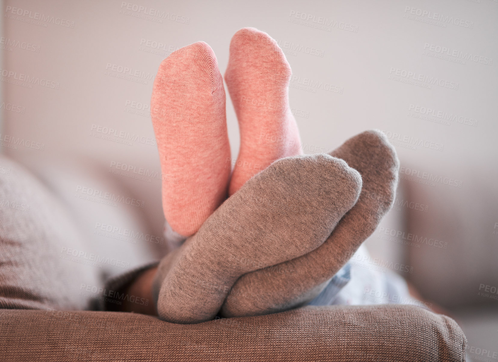 Buy stock photo Cropped shot of an unrecognizable couple's sock-covered feet