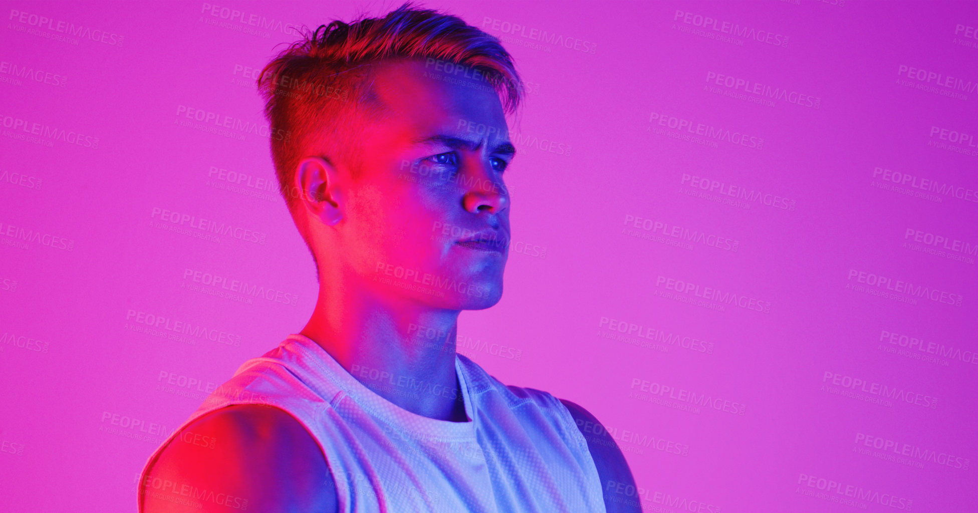 Buy stock photo Studio shot of a handsome young man posing against a purple background