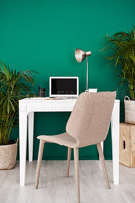 Buy stock photo Still life shot of various items at a workstation against a green wall in an office
