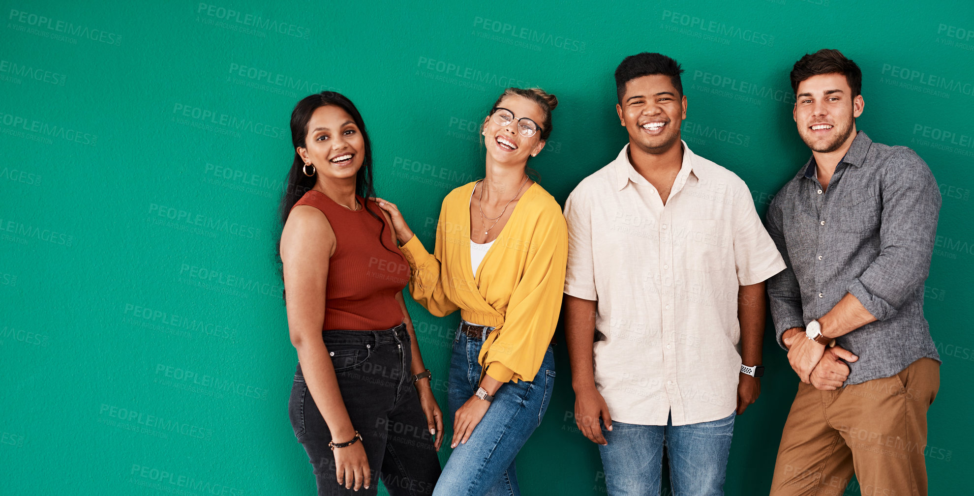 Buy stock photo Portrait of a group of young designers standing together against a green background