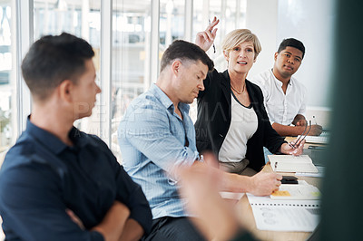 Buy stock photo Shot of a mature businesswoman raising her hand to ask questions during a meeting