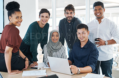 Buy stock photo Shot of a group of businesspeople using a laptop during a meeting in a modern office