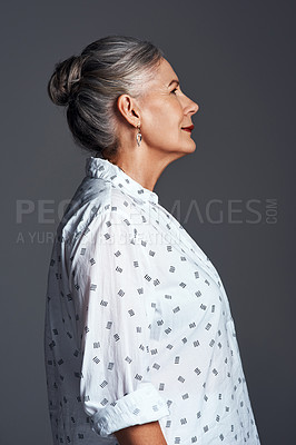 Buy stock photo Studio shot of a senior woman posing against a grey background