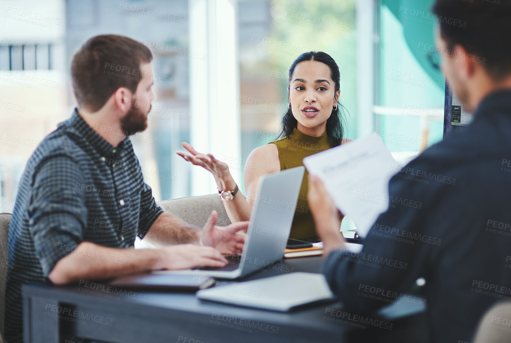 Buy stock photo Shot of a group of young designers having a discussion in an office