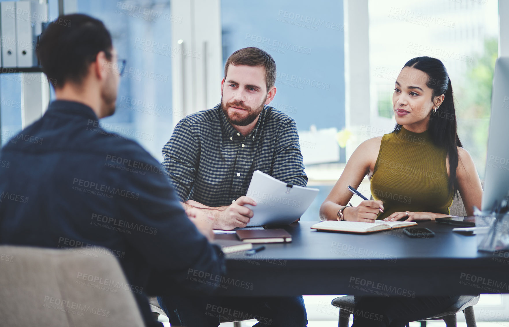 Buy stock photo Shot of a group of young designers having a discussion in an office