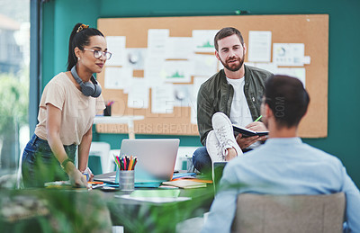 Buy stock photo Shot of a group of young designers having a discussion in an office