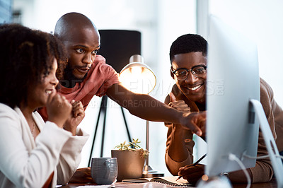 Buy stock photo Shot of a group of businesspeople looking at something on a computer screen in an office