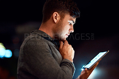 Buy stock photo Cropped shot of a businessman using a digital tablet while standing outside