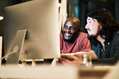 Buy stock photo Cropped shot of two young designers working together at night