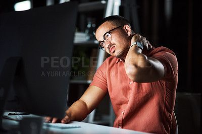Buy stock photo Cropped shot of a businessman experiencing neck pain while working late at the office