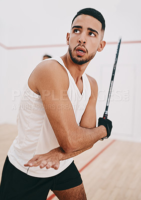 Buy stock photo Shot of a young man playing a game of squash