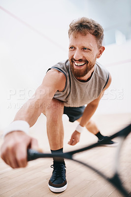 Buy stock photo Shot of a young man playing a game of squash