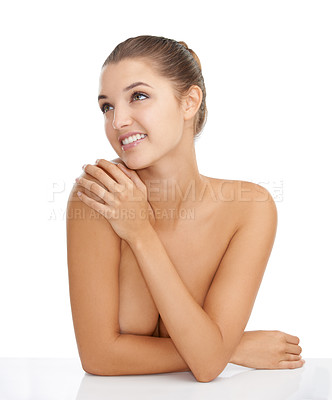 Buy stock photo Cropped shot of a gorgeous young woman looking away with a smile while posing nude against a white background