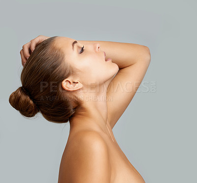 Buy stock photo Cropped shot of a gorgeous young woman posing nude against a grey background