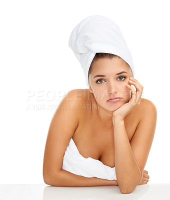 Buy stock photo Cropped portrait of a gorgeous young woman looking bored while wrapped in towels against a white background
