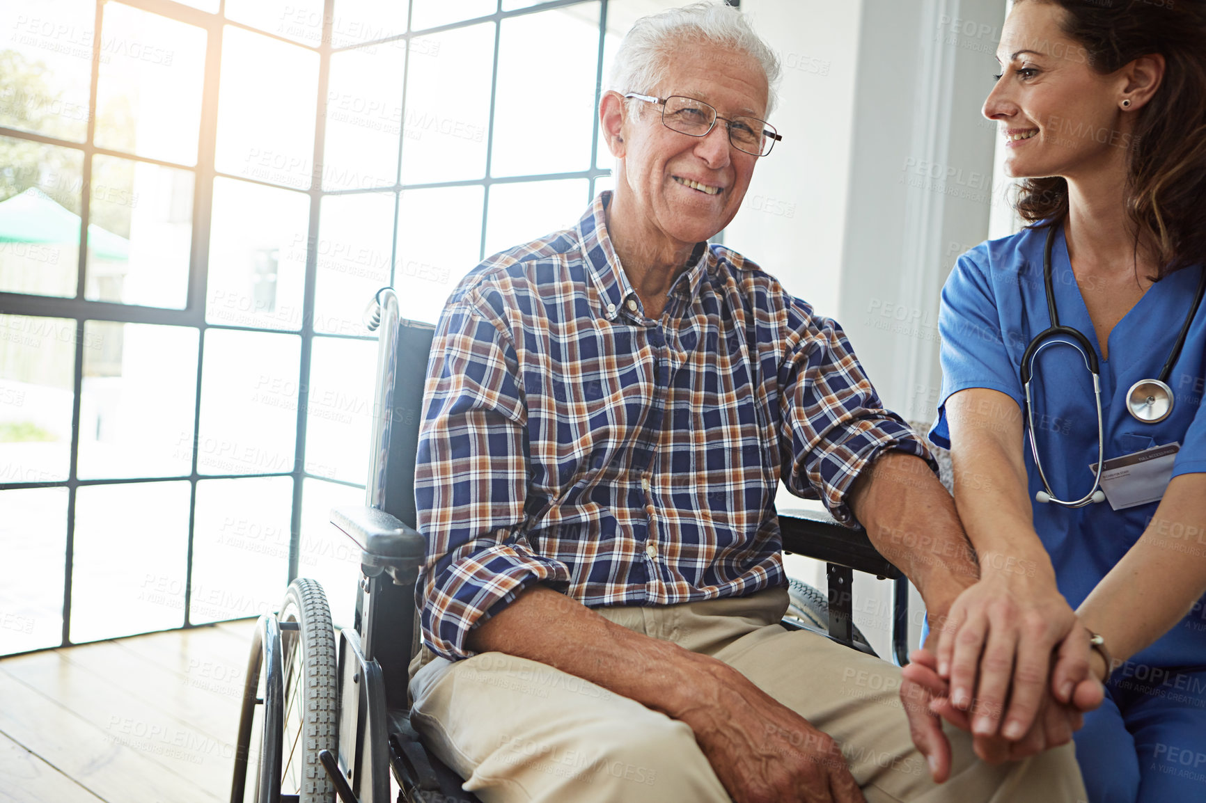 Buy stock photo Cropped shot of a female nurse talking to a senior patient in the retirement home