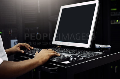 Buy stock photo Cropped shot of an unrecognizable IT technician using a computer while working in a data center