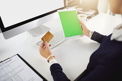 Buy stock photo Shot of an unrecognizable young businesswoman holding a bank card and a tablet in a modern office